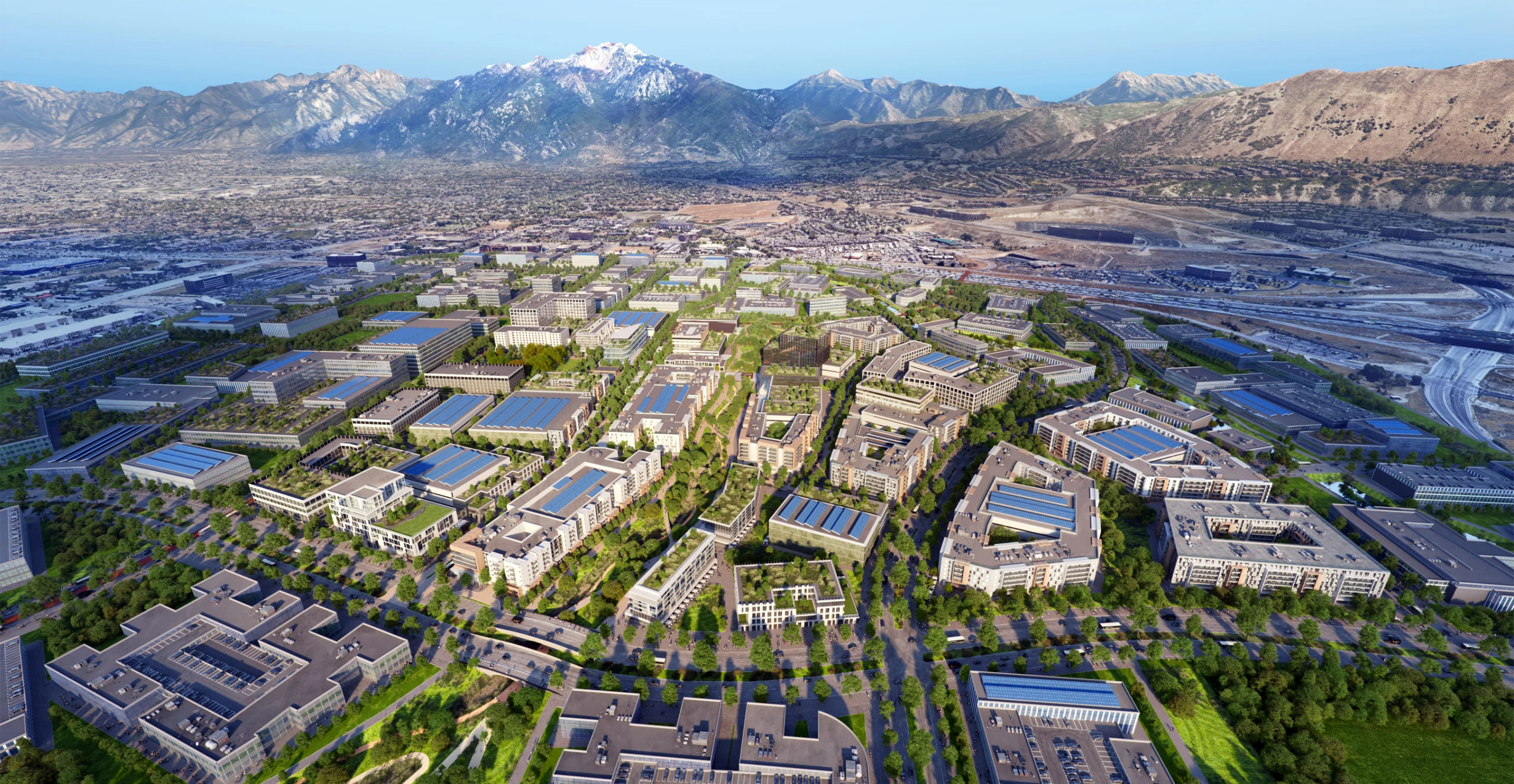 An expansive aerial view of a modern, master-planned urban development nestled at the foot of majestic, snow-capped mountains. The layout features a mix of residential, commercial, and green spaces, with tree-lined streets and buildings equipped with large solar panel installations. The design emphasizes sustainability, innovation, and connectivity, with open spaces, pedestrian pathways, and clusters of contemporary architecture. The surrounding landscape blends seamlessly with the cityscape, creating a balance between urban living and the natural environment.