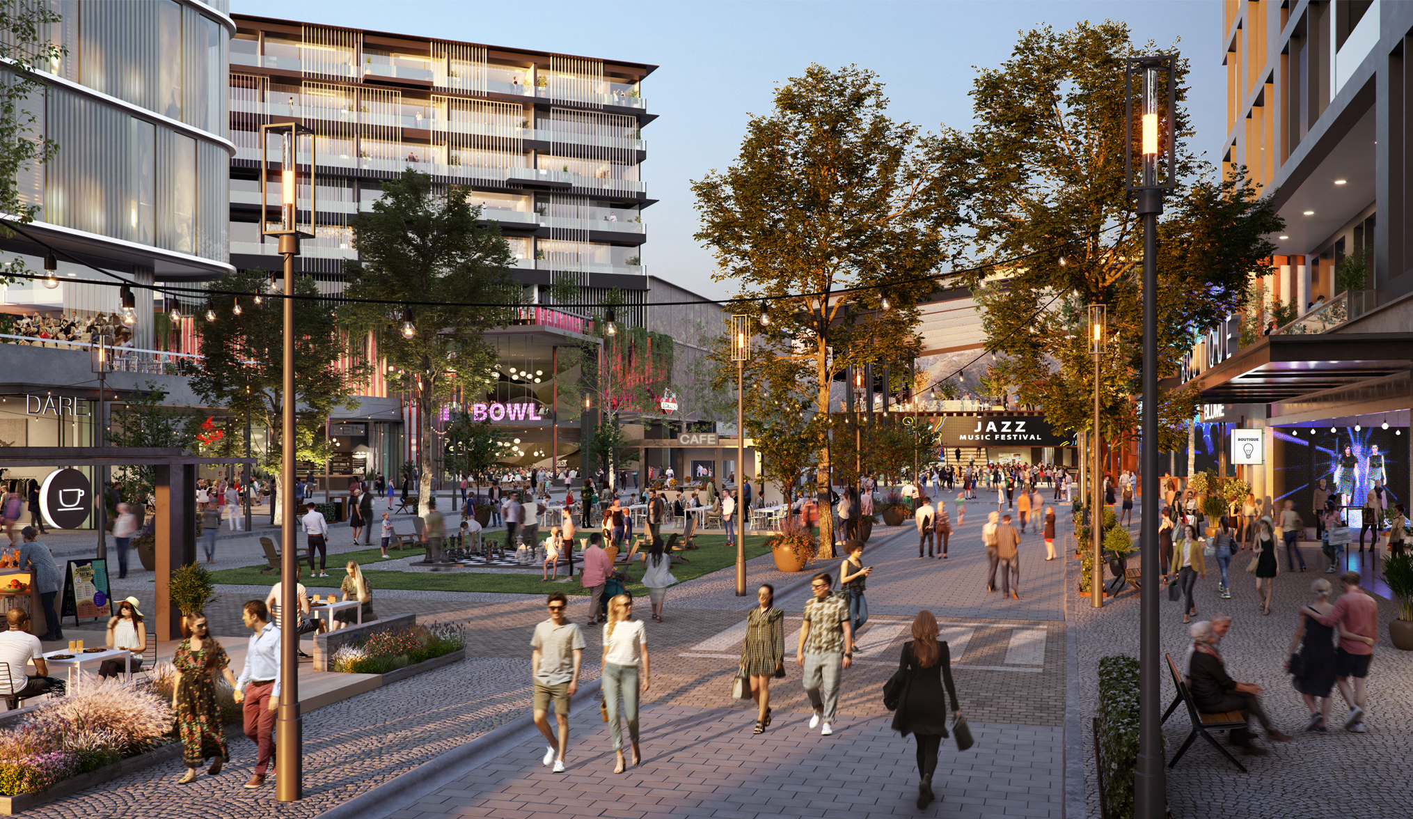 A vibrant urban plaza at twilight, filled with people enjoying an evening out. The scene showcases a lively atmosphere with illuminated signs for a bowling alley, a jazz music festival, and cafes. String lights and sleek modern lampposts create a warm glow over the cobblestone walkways. People stroll along the pedestrian-friendly paths, sit at outdoor cafes, and gather in green spaces. Surrounding buildings feature contemporary architecture with balconies overlooking the plaza. The mix of entertainment, dining, and social spaces emphasizes a sense of community and modern urban living.